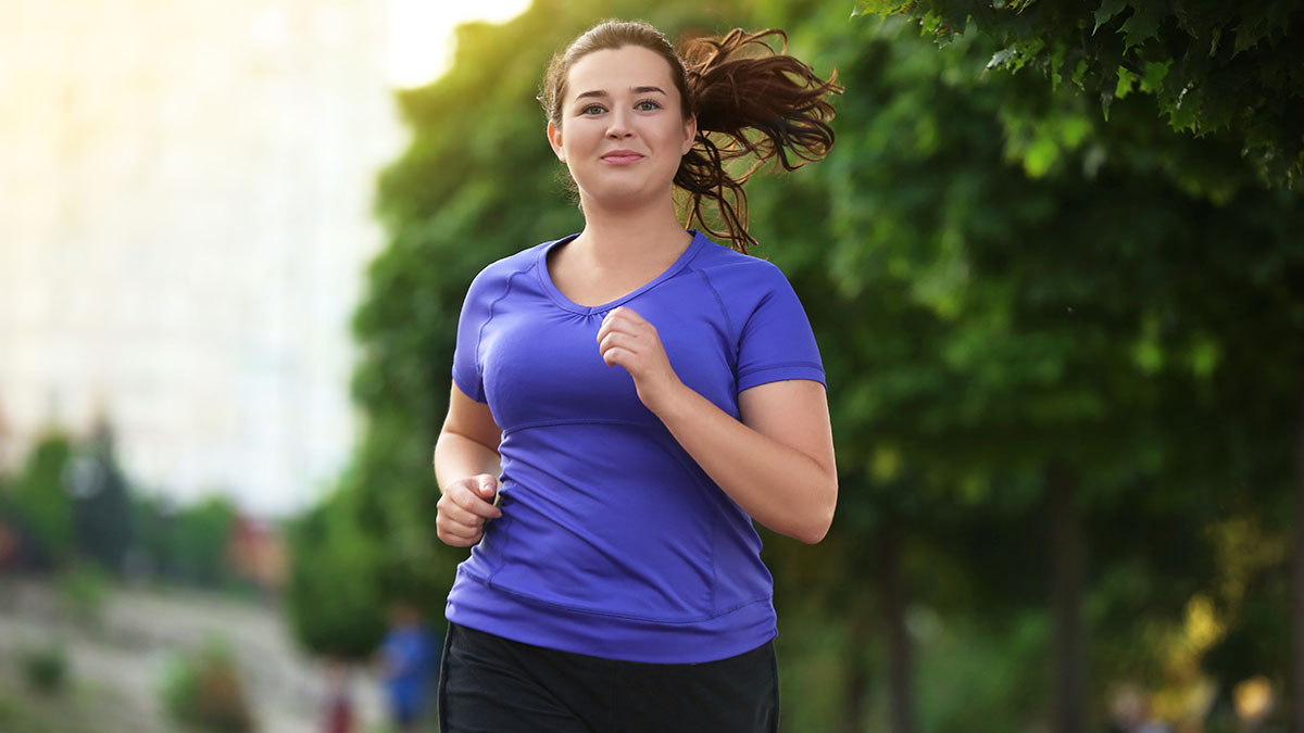 Overweight,Young,Woman,Jogging,In,The,Street.,Weight,Loss,Concept