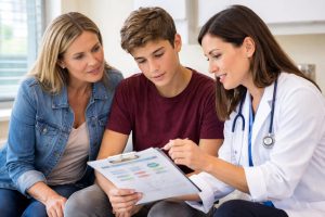 signs of metabolic dysfunction in teens — parent and teenager reviewing lab results with doctor