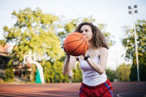 Teen girl with PCOS doing a fun activity outdoors — walking, dancing or playing basketball